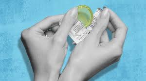 Empowering moments: Woman opens a condom pack, prioritizing safe sex.