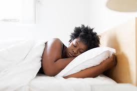 Woman soundly asleep, emphasizing the importance of rest to address hormone imbalance.
