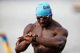 Pre-swim routine: athlete at the swimming poolside checking watch