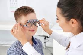 Child being fitted with protective eyewear for vision safety.