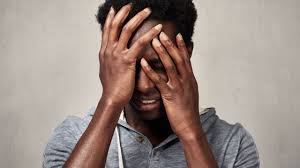 person holding head and crying, depicting emotional distress