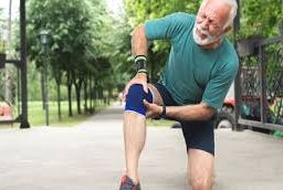 Man performing knee stretches, highlighting the importance of flexibility exercises in managing and preventing chronic pain.