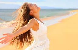 Woman with Open Arms Enjoying the Sun - Embracing Nature and Vitamin D Benefits