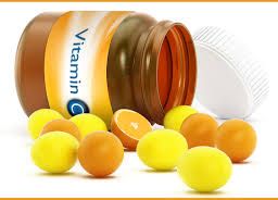 Close-up of a fallen bottle with scattered Vitamin C pills.