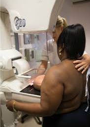 Woman undergoing mammograms screening for breast health.