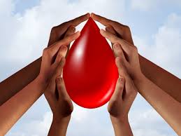 Diverse hands encircling a drop of blood, symbolizing unity and the collective effort in donating to save lives.