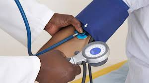 Healthcare professional measuring blood pressure in hospital setting
