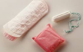 Sanitary pad placed on a surface, designed for menstrual hygiene, featuring an absorbent layer and adhesive backing for secure placement in undergarments.