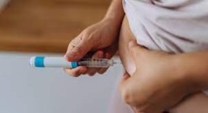 Man administering insulin, emphasizing Diabetes Awareness and management.