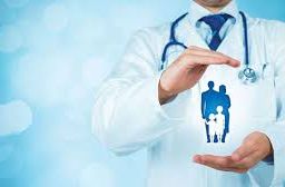 Doctor's hands forming a protective cup over a family symbol: Health Insurance coverage