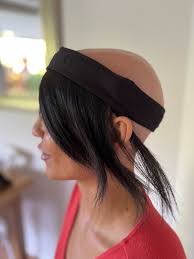 A woman wearing a tiara made of hair, symbolizing beauty and addressing the topic of hair loss.