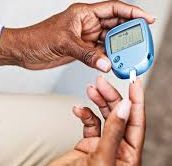 A diabetic patient checking blood sugar levels using a glucose meter and a test strip.