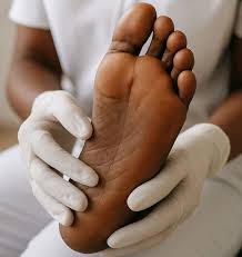 nurse checking diabetic foot for ulcers